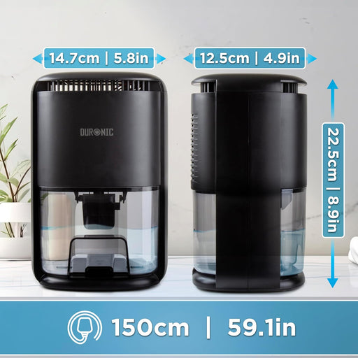 Duronic DH07 BK, deshumidificador eléctrico portátil, colocado sobre un escritorio junto a un portátil y una planta, en un ambiente luminoso junto a una ventana